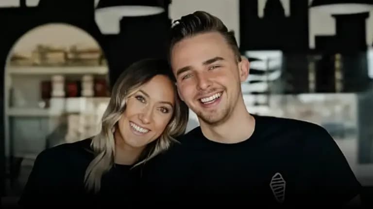 Jeremy and Kaitlyn Carlson smiling together inside a Crispy Cones dessert shop, wearing black branded shirts.