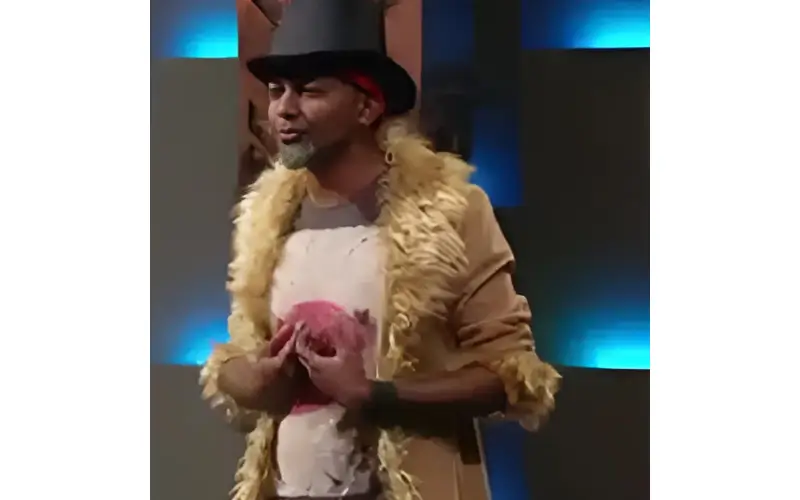 Capital M, founder of Hoo Haa Headphones, wearing a top hat and fur-trimmed coat on Shark Tank Australia
