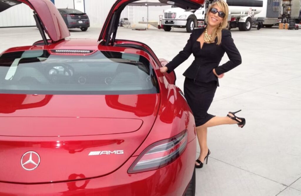 Lori Greiner with her luxury red Mercedes Benz SLS AMG