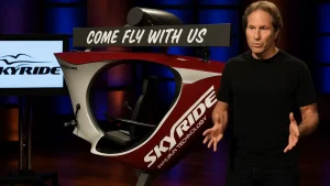 Scott Olson presenting the SkyRide bike concept during his Shark Tank Season 3 pitch, showcasing the suspended rail fitness technology.