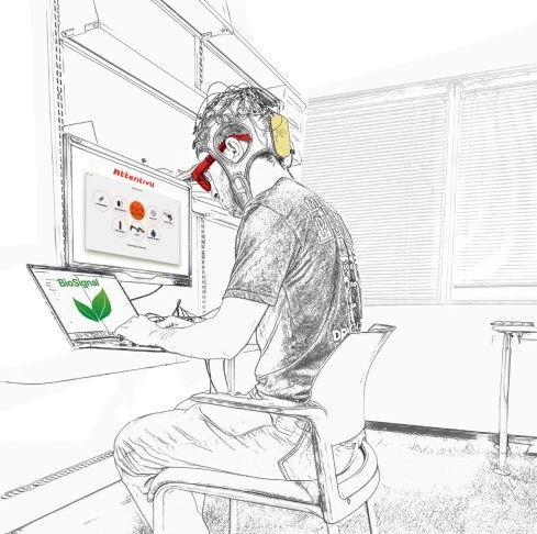 Participant during the session, while wearing Enobio headset, AttentivU headset, using BioSignal recorder