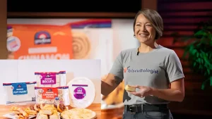 Chanel Diong presenting GoodLove Foods' gluten-free baked products on Shark Tank, including biscuits, cinnamon rolls, puff pastry, and pizza crust.