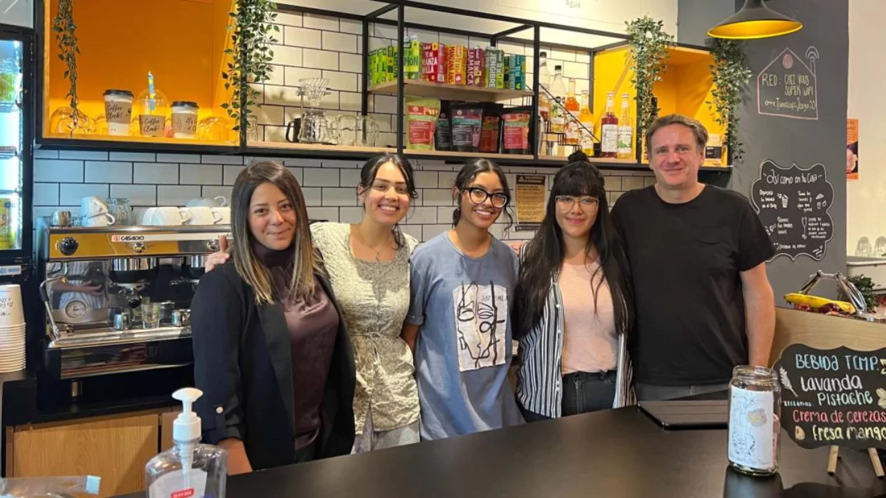 Staff members of Chez Vous Time Café posing behind the counter at one of their Mexico City locations after Shark Tank success.