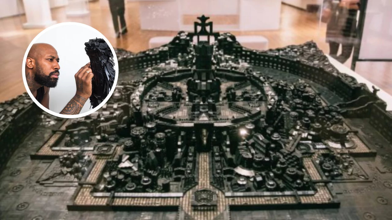 Ekow Nimako sculpting a detailed all-black LEGO model of a futuristic African city, Kumbi Saleh 3020 CE, on display in an art gallery.
