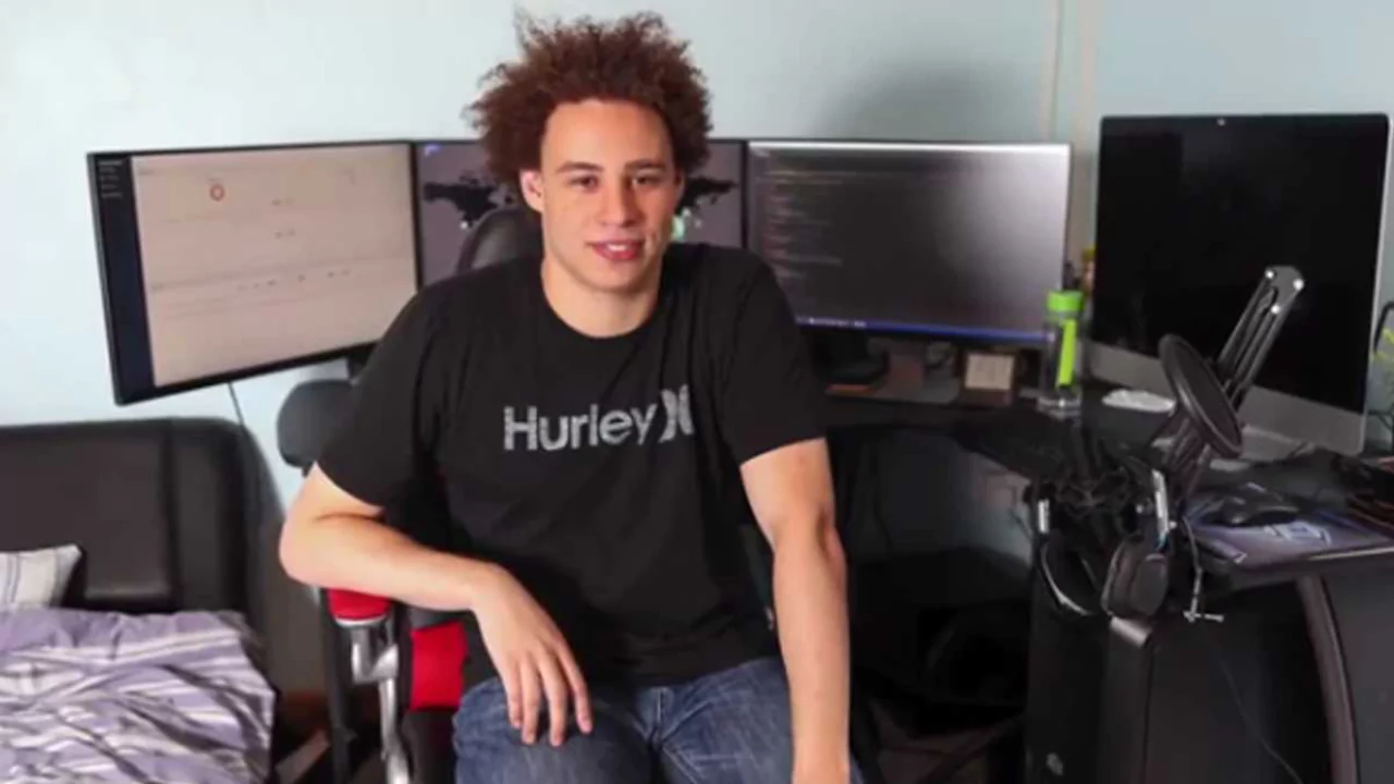 Marcus Hutchins sitting in front of multiple monitors in his home office where he discovered the WannaCry kill switch