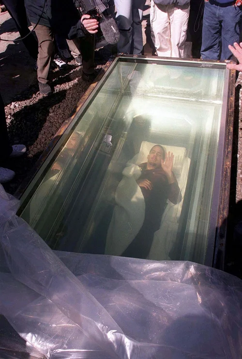 David Blaine lies inside a transparent coffin beneath a water-filled tank during his 1999 Buried Alive endurance stunt in New York.